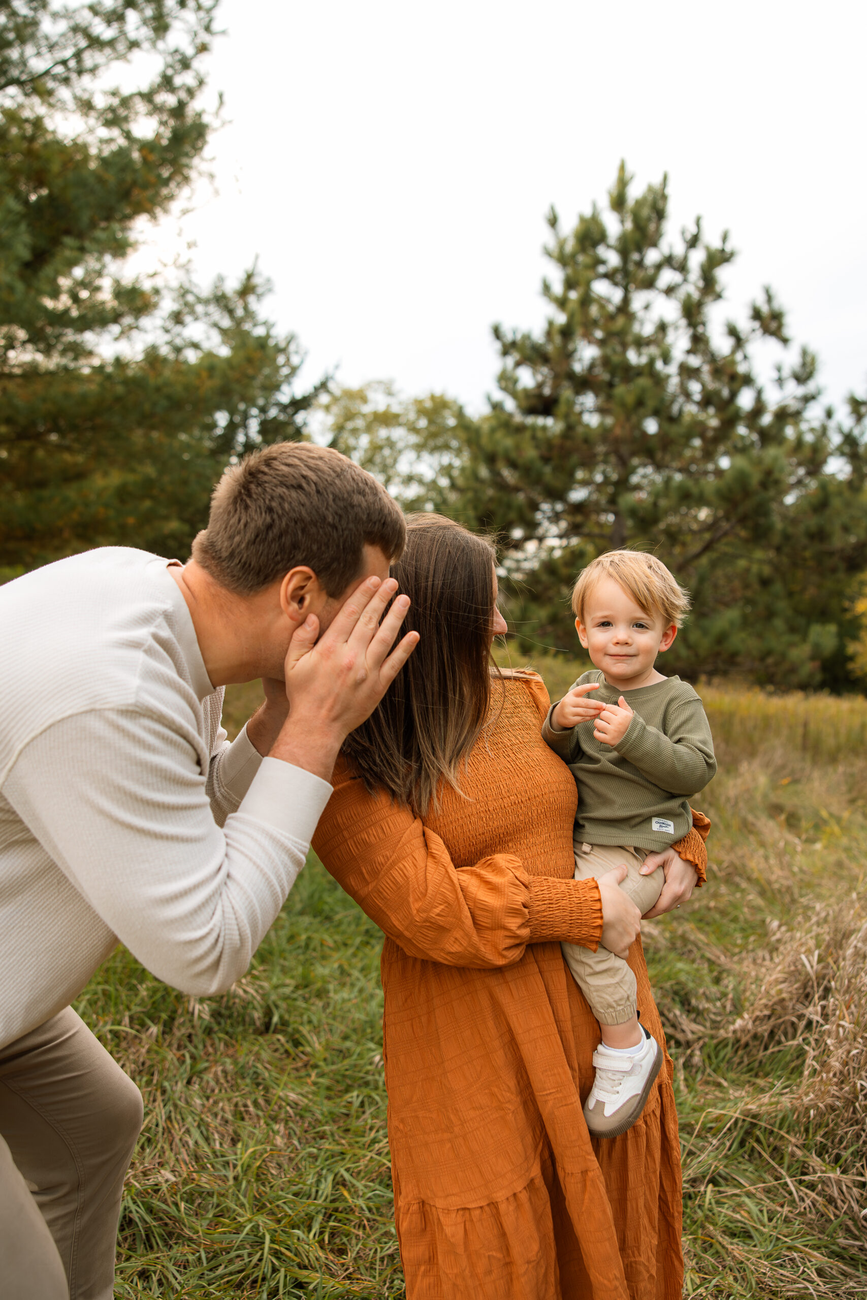 family photo session of family with younger boy in delafield Wisconsin during golden hour in Wisconsin