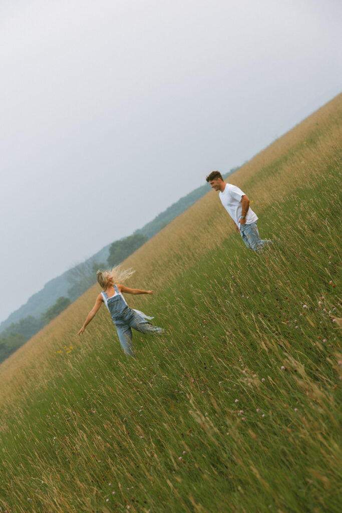 Couple running toward each other through a grassy field during an outdoor couples session