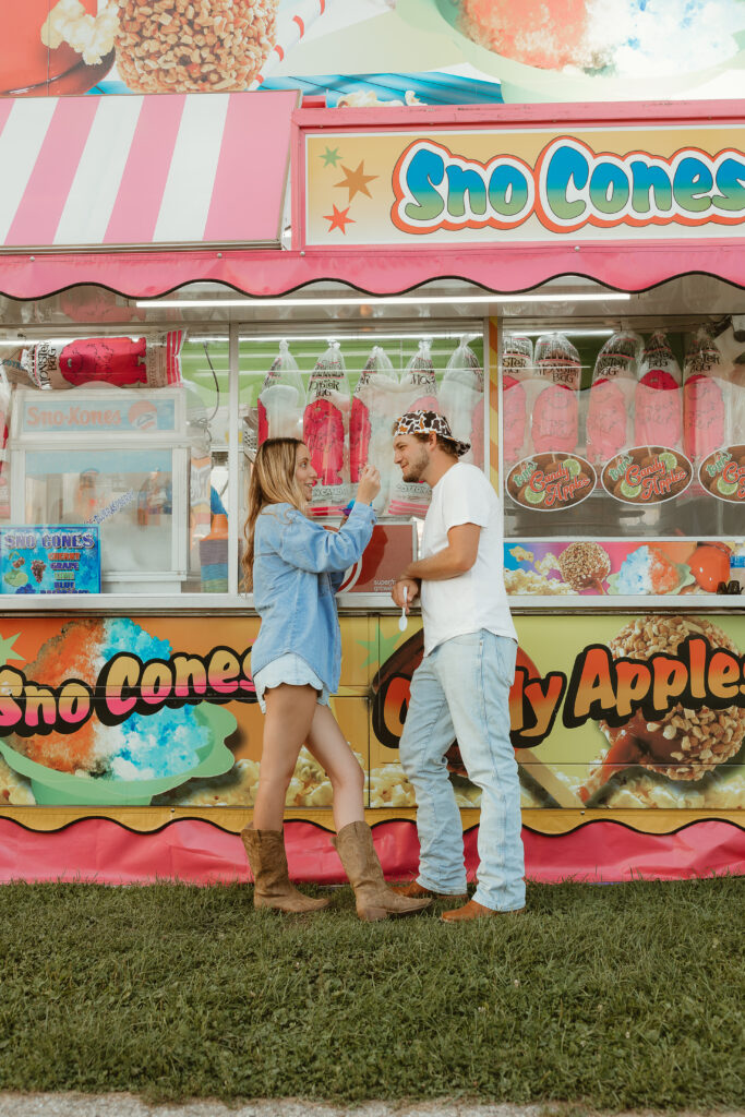 Couple laughing under carnival lights at the Walworth County Fair