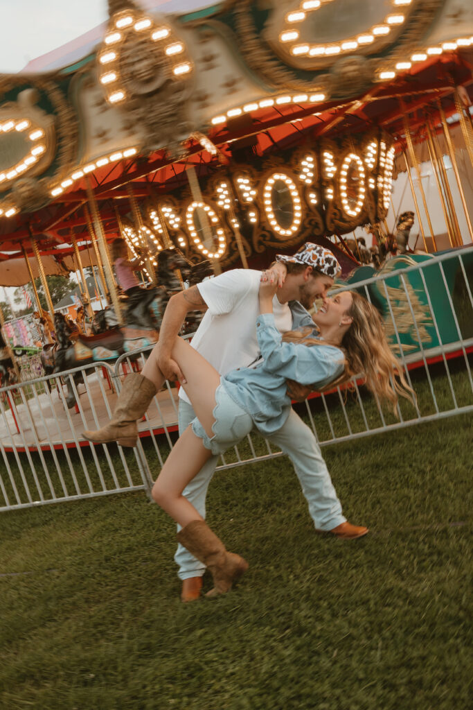 Romantic couples session surrounded by carnival lights in Wisconsin